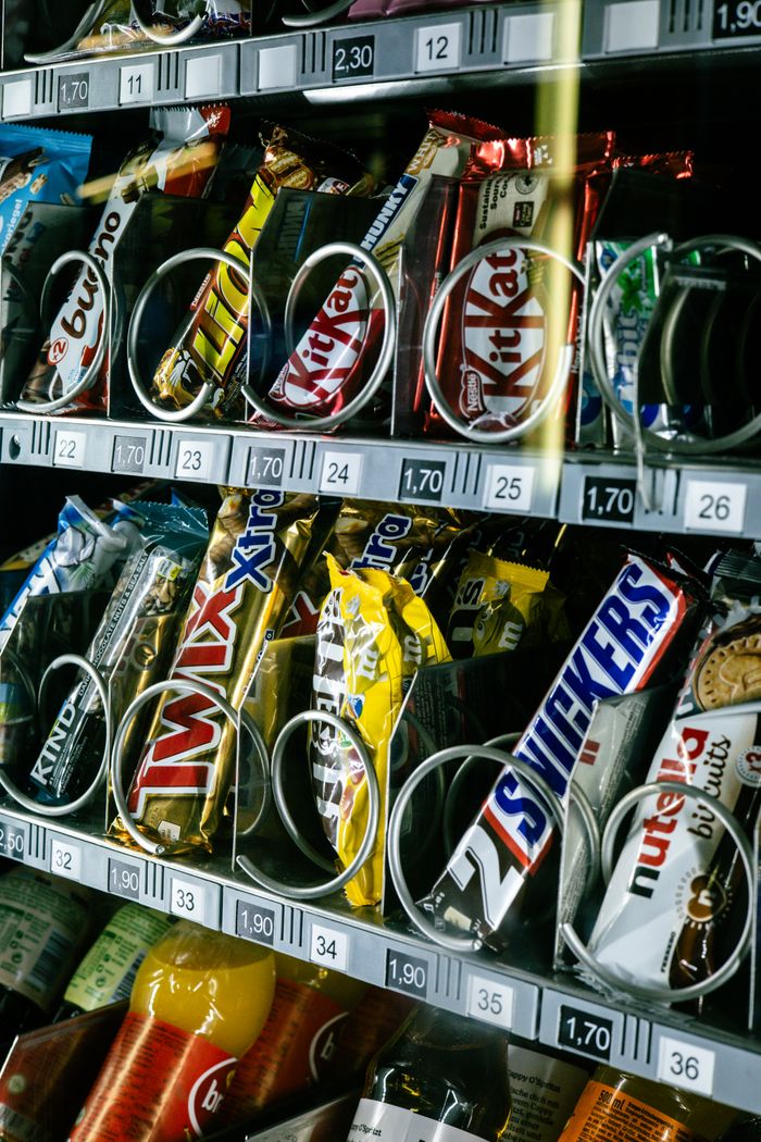 Close-up of a snack vending machine filled with various chocolates in Kapfenberg, Austria.